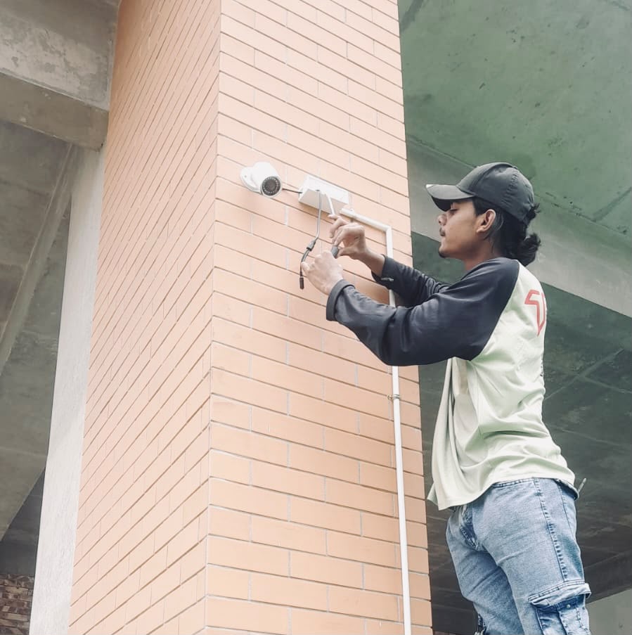 Woman standing with surveillance cameras